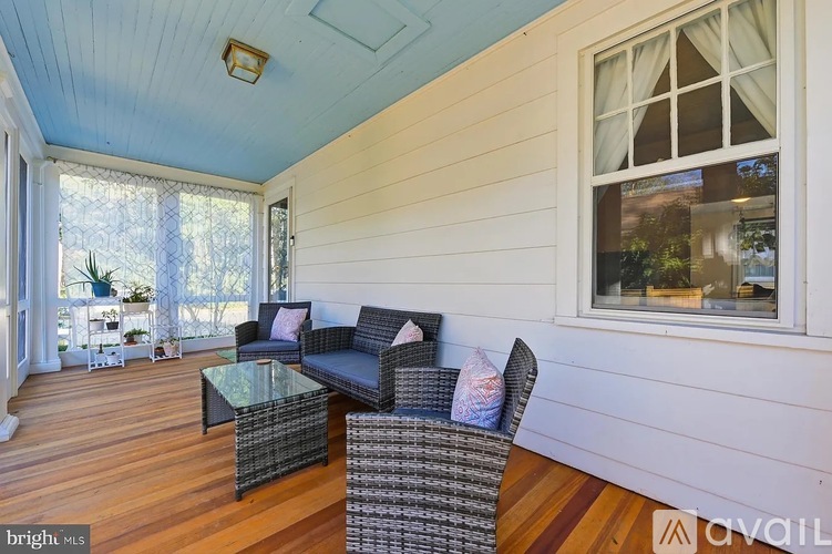 A sunny day in a living room with a glass table and two chairs.