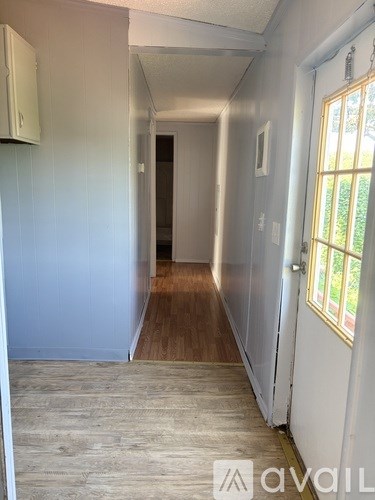 A long hallway with a door at the end.