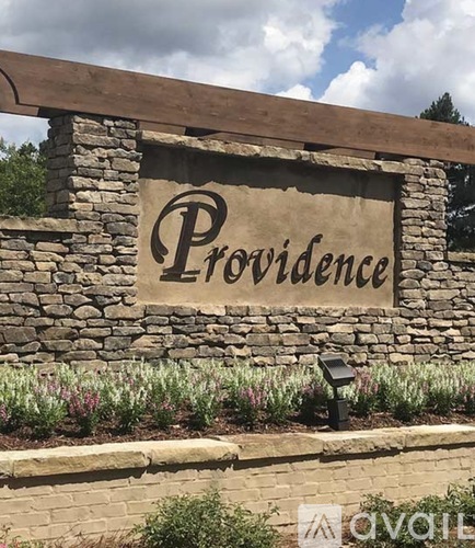 A stone wall with a sign that says Providence.