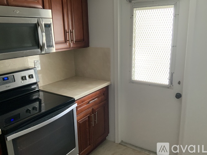 A kitchen with a stove top oven and microwave.
