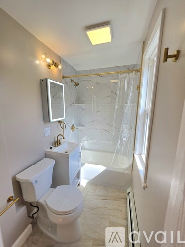 A white toilet is next to a white sink in a bathroom.
