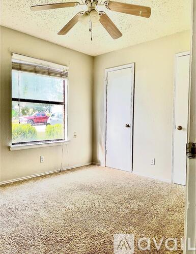 A room with a car parked outside the window.