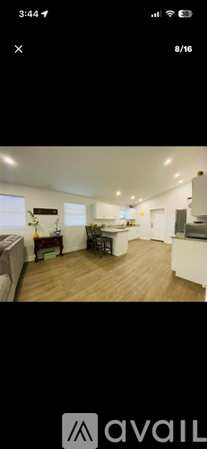 A well-lit, spacious kitchen and living room area.