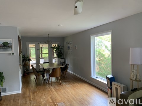 A living room with a dining table and chairs.