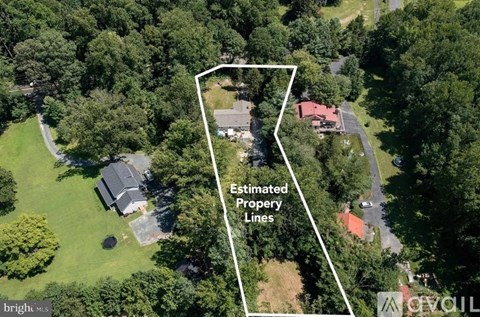 An aerial view of a property with a white boundary line indicating the estimated property lines.