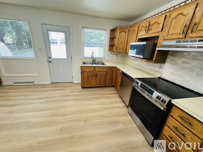 A kitchen with wooden cabinets and a black stove top oven.