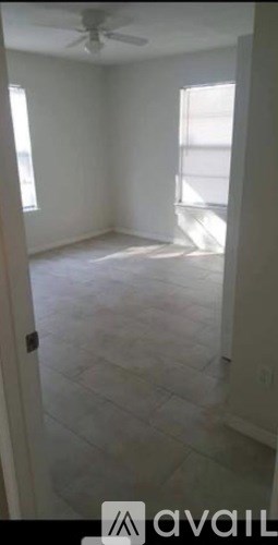 A room with a tiled floor and a ceiling fan.