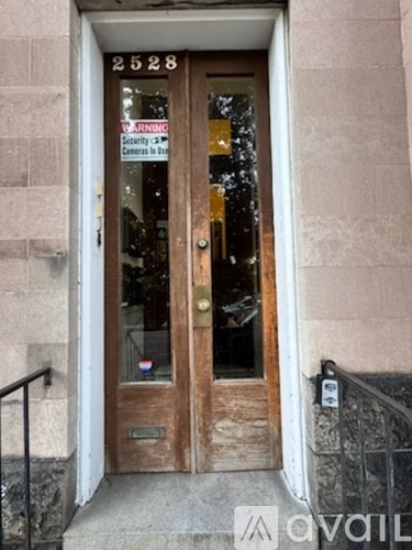 A brown door with a glass window and a sign on it.
