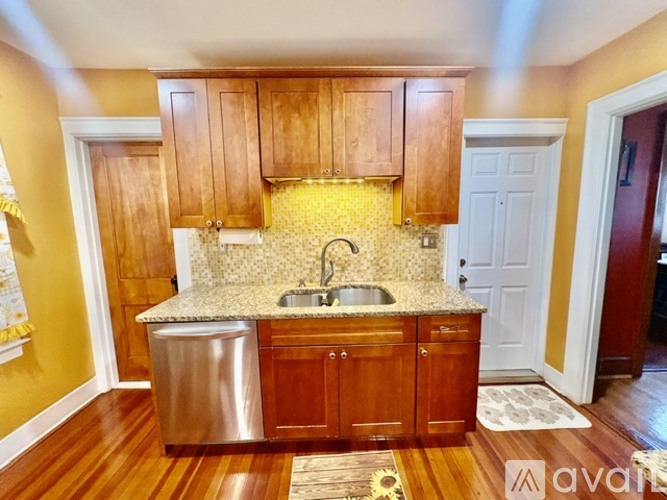 A kitchen with wooden cabinets and a granite countertop.