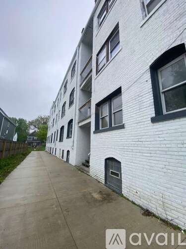 A white building with a grey door and windows.