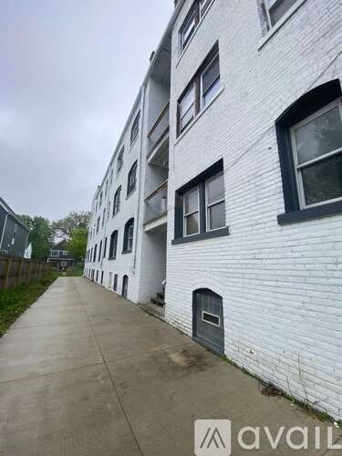 A white building with a grey door and windows.