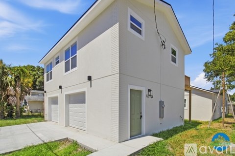A two-story house with a garage is for sale.