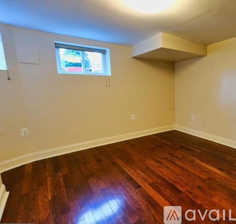 A room with wooden floors and a window.