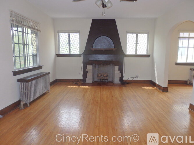 A room with a wood burning stove in the middle.