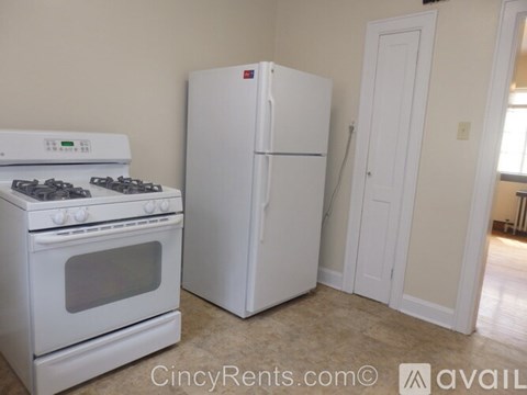 A white stove and refrigerator in a kitchen.