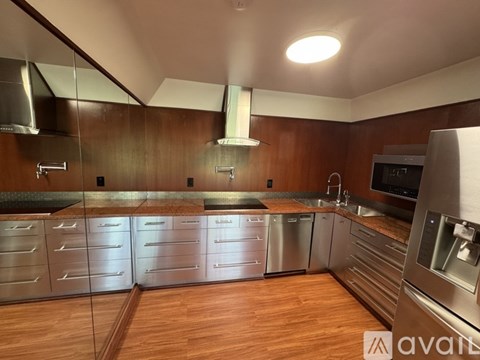 A kitchen with wooden cabinets and stainless steel appliances.