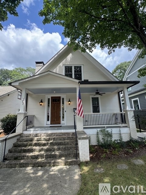 A house with a flag on the front porch.