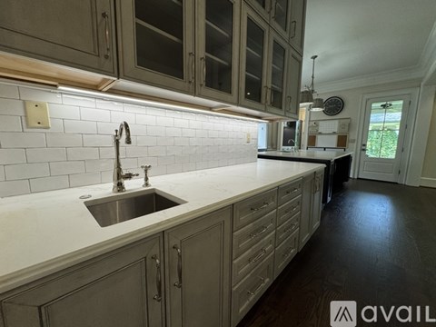 A kitchen with a sink and cabinets.