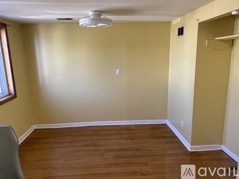 A room with wooden floors and a ceiling fan.