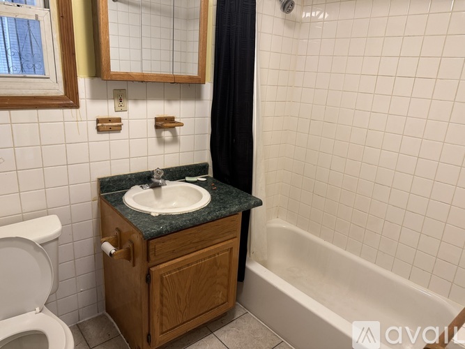 A bathroom with a sink, toilet, and bathtub.