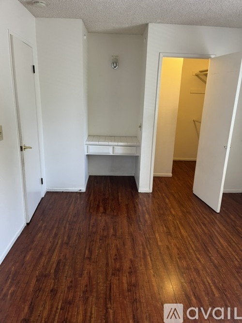 A room with wooden floors and white walls.