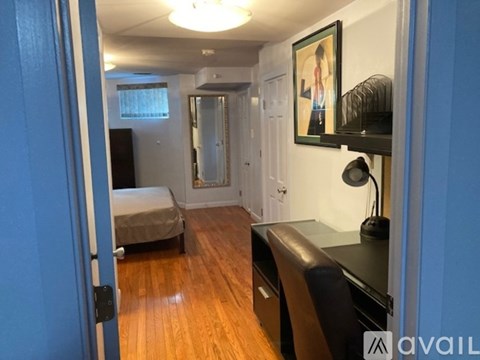 A bedroom with a bed, desk, and chair.
