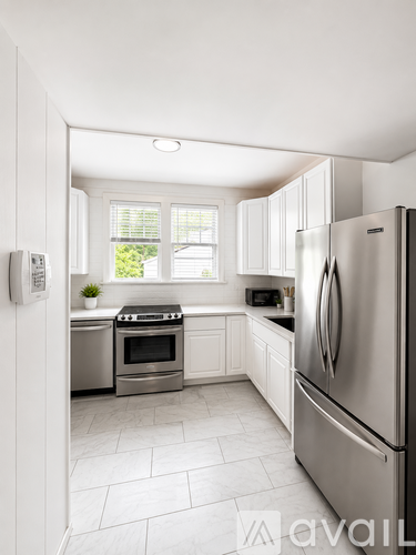 A modern kitchen with a stainless steel refrigerator and a dishwasher.