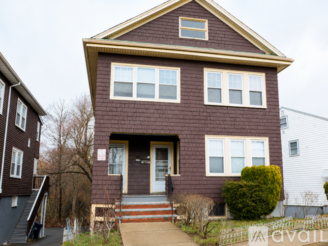 A brown house with a white door and windows.