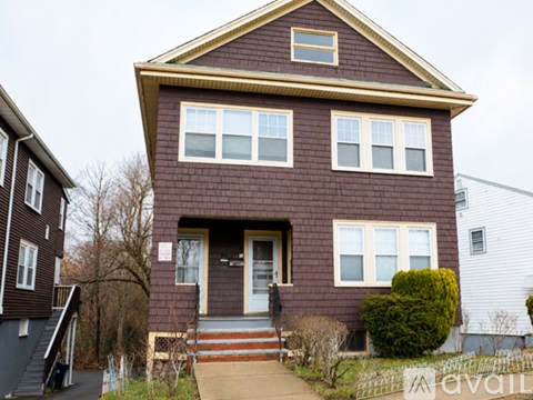 A brown house with a white door and windows.