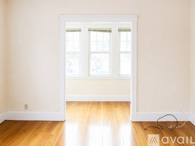 A room with a wooden floor and a window.