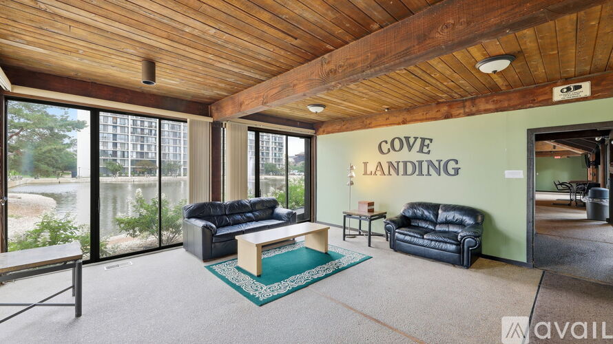 A living room with a couch and a coffee table in front of a large window.