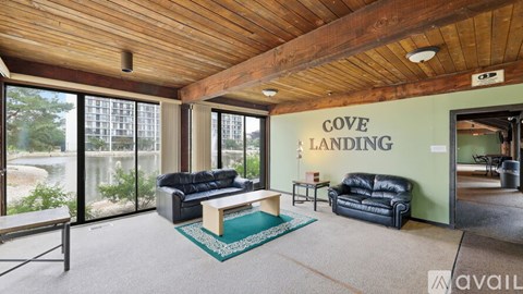 A living room with a couch and a coffee table in front of a large window.