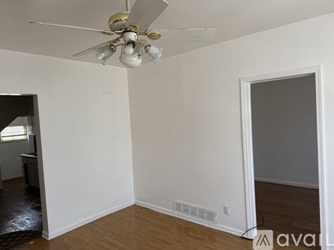 A room with a ceiling fan and a window.