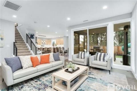 A living room with a white couch and a coffee table.