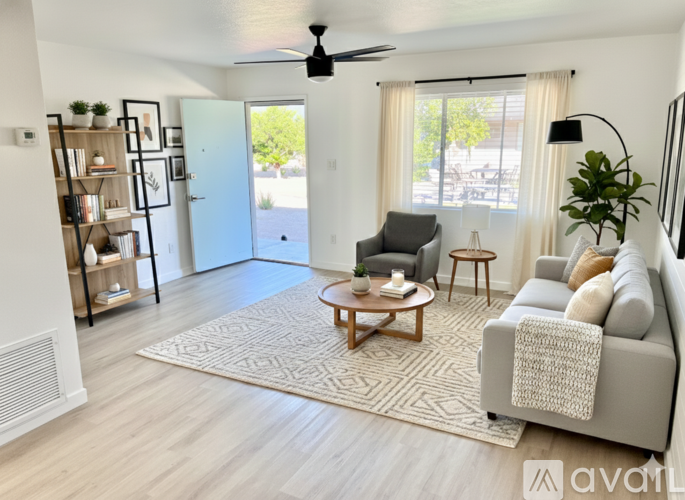 A living room with a grey couch, a wooden coffee table, and a ceiling fan.