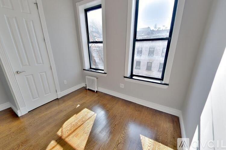 A room with a white door and a window with a white frame.