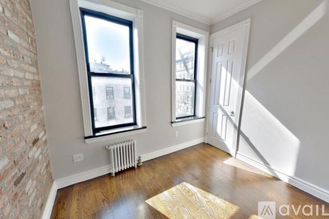 A room with a brick wall and a wooden floor.