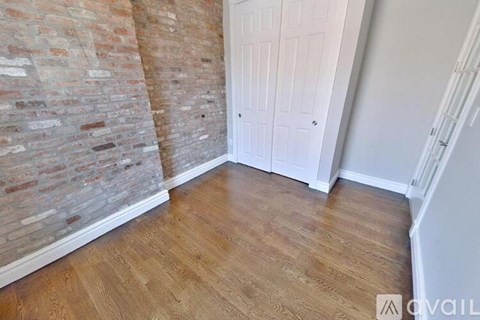 A room with a wooden floor and a white door.