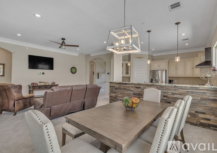 A modern dining room with a wooden table and chairs.