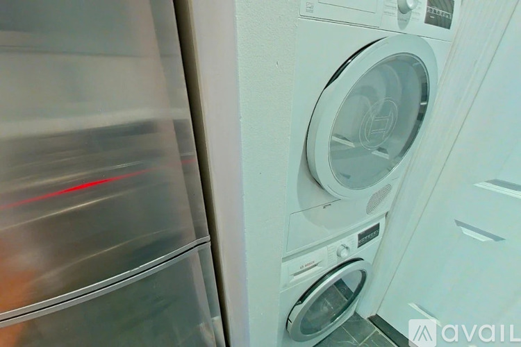A washing machine is in the foreground with a blurred background.