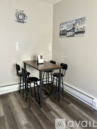A dining room with a table and chairs.