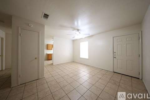 A kitchen with white appliances and brown cabinets.