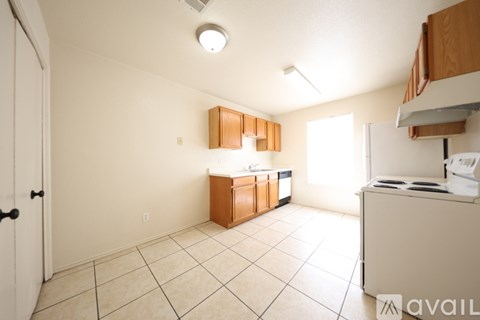 A kitchen with white appliances and brown cabinets.