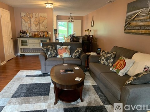 A living room with a grey couch and a coffee table.