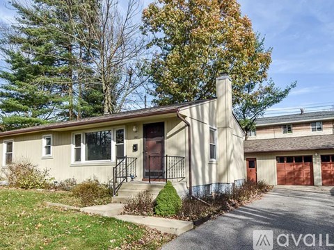 A house with a garage is for sale.