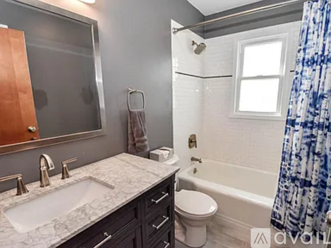 A bathroom with a sink, toilet, and bathtub.