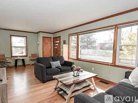 A living room with a grey couch and a coffee table.