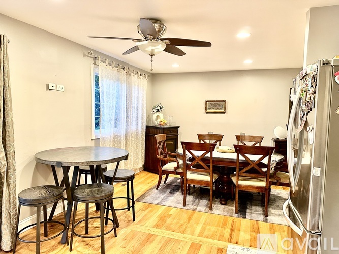 A kitchen with a table and chairs in the middle of the room.