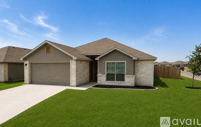 A house with a garage and a driveway is available for sale.