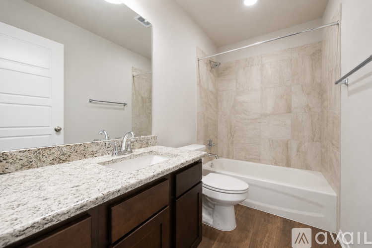 A bathroom with a marble countertop and a white toilet.